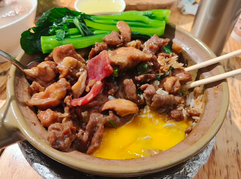 Cantonese claypot rice with meat, egg yolk and Chinese greens at Mingji Claypot Rice